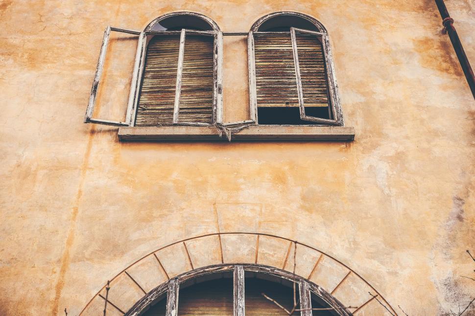 Free Image of Old rustic windows on a weathered wall 