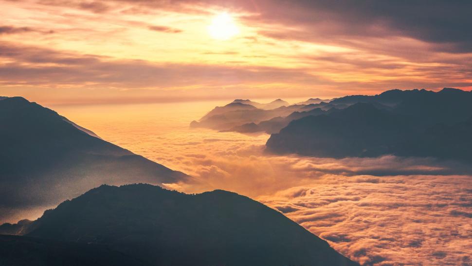 Free Image of Golden sunrise above sea of clouds in the mountains 