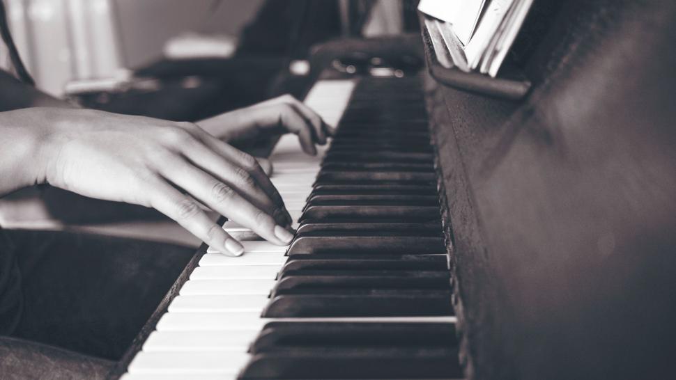 Free Image of Person practicing on a black and white piano 