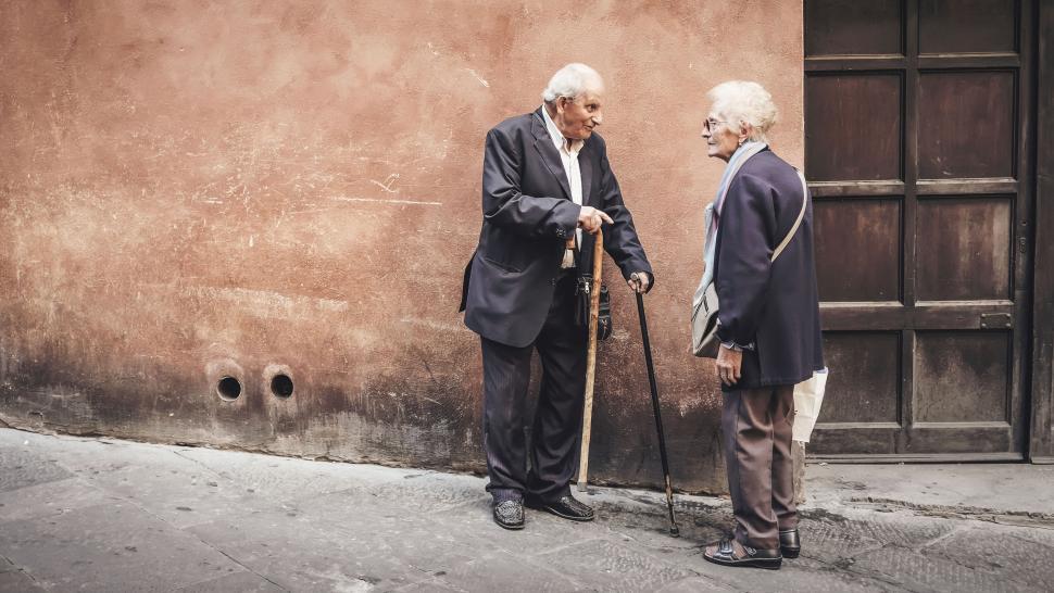 Free Image of Two elderly men conversing on a street 