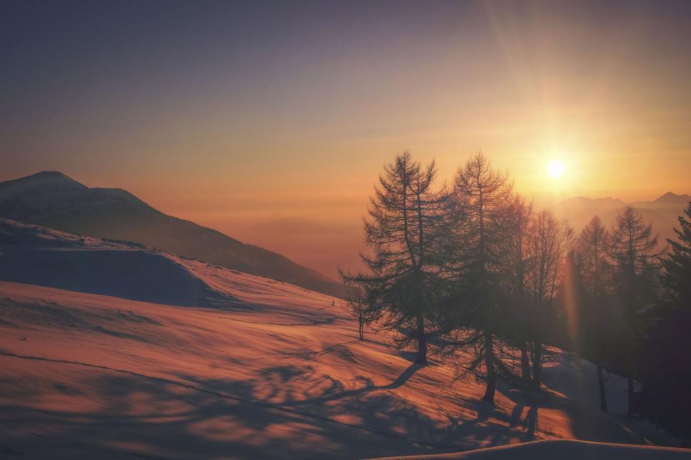 Free Image of Sunset silhouette on snowy mountain range 