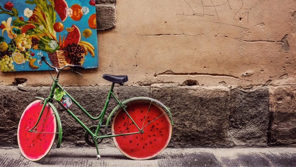 Free Image of Watermelon bicycle against a wall 