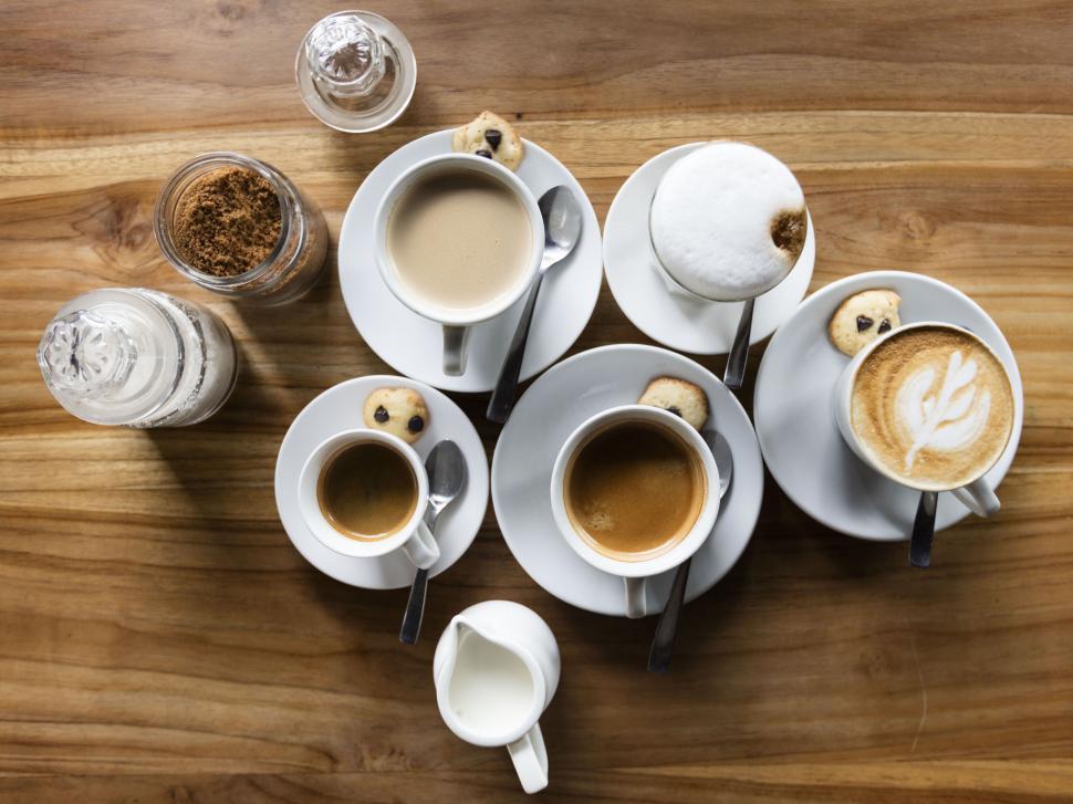 Free Image of Assorted coffee cups on a wooden table 