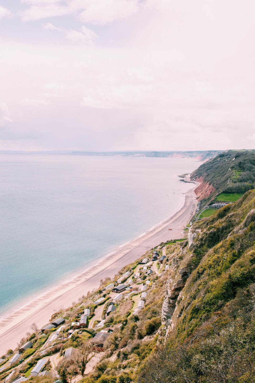 Free Image of Coastal cliffside with caravans and sea view 
