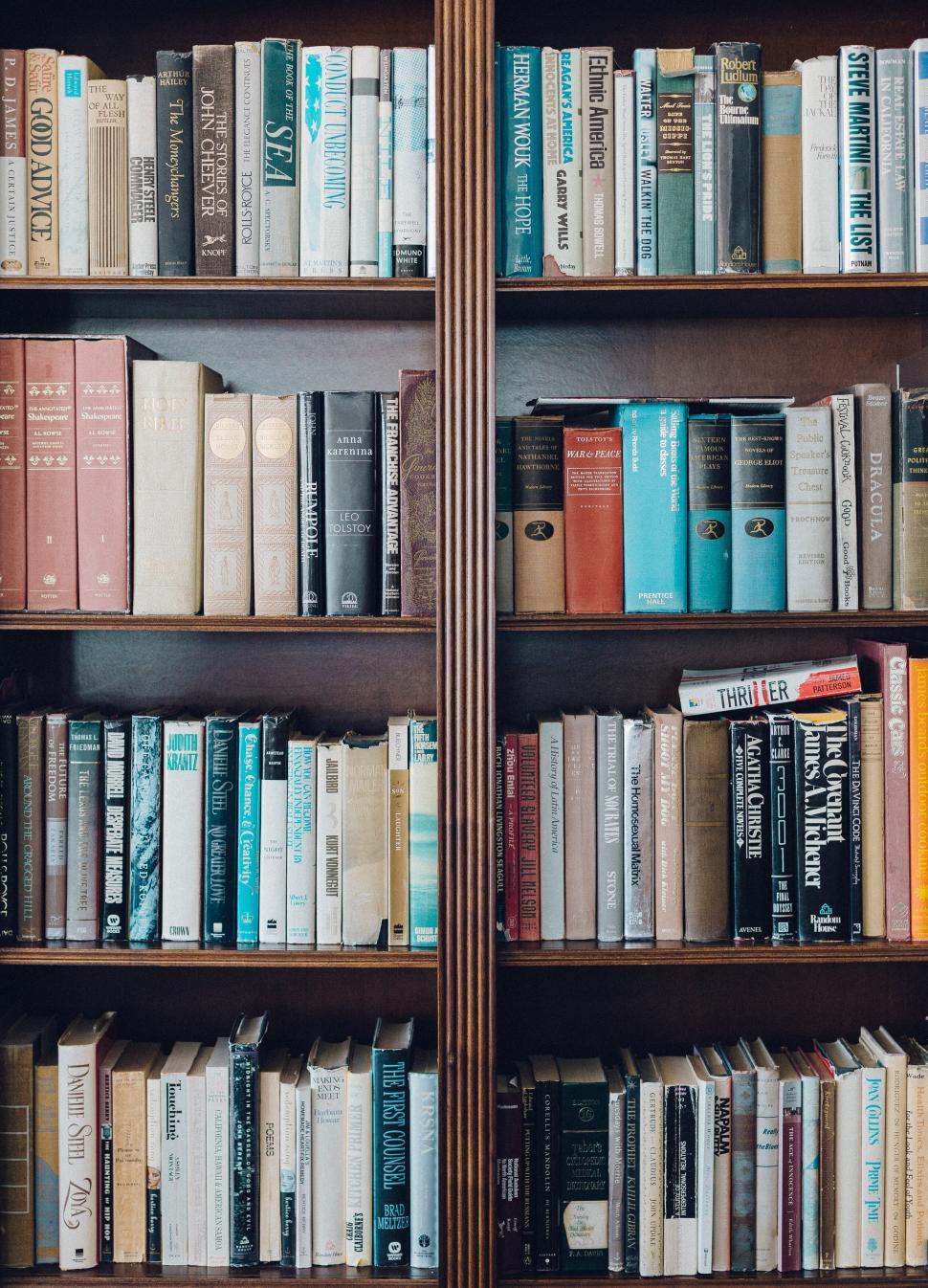 Free Image of Library bookshelf filled with various books 