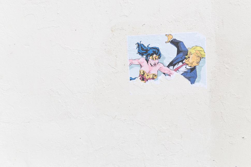 Free Image of Anime characters sticker on a white wall 