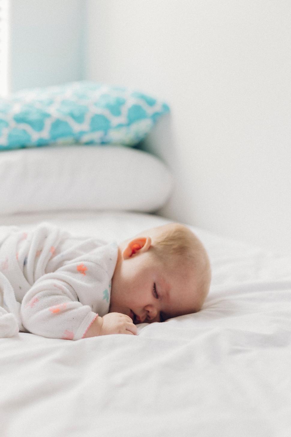 Free Image of Baby resting peacefully in a bright room 