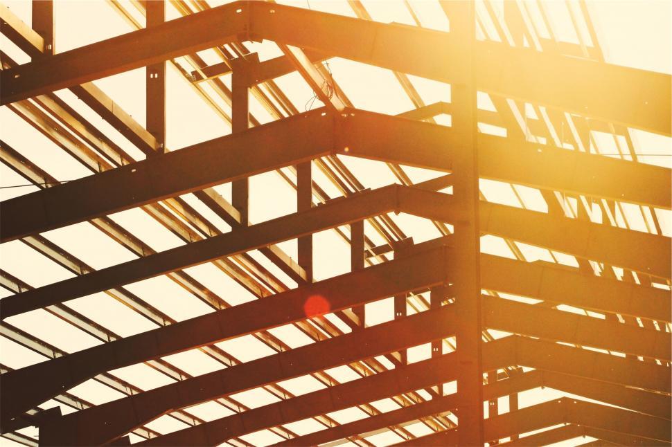 Free Image of Golden sunlight through steel beams structure 