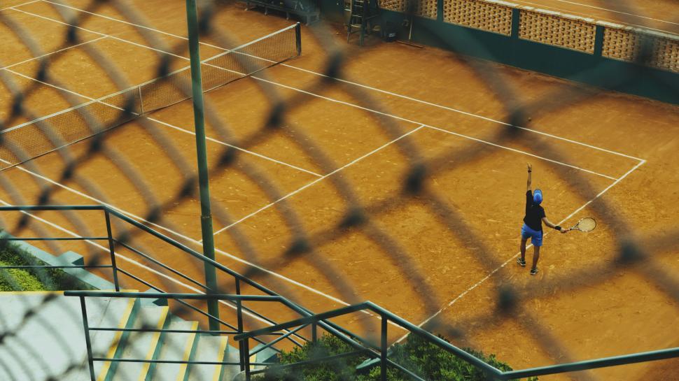 Free Image of Aerial view of a tennis player on a clay court 