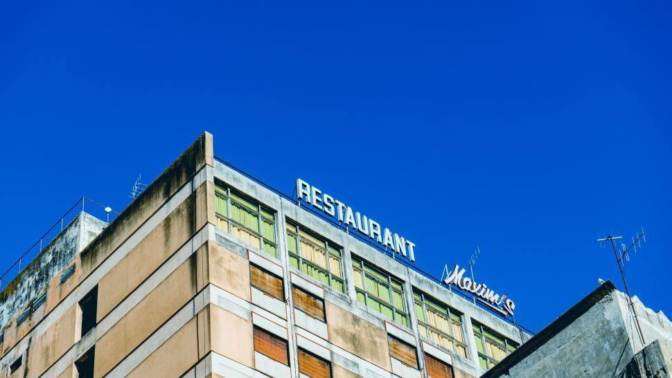 Free Image of Top angle shot of a restaurant sign on a building 