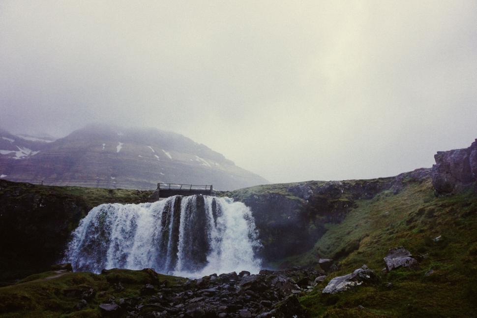 Free Image of Majestic waterfall in serene landscape 