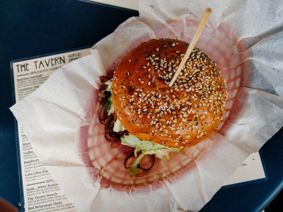 Free Image of Gourmet burger with sesame bun on paper 