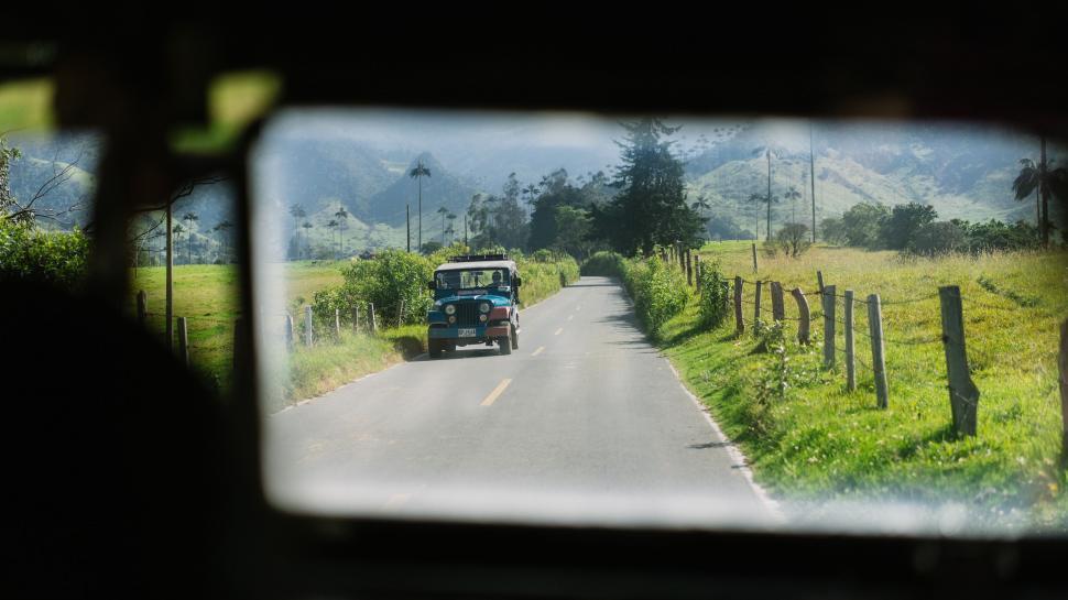 Free Image of View from the backseat of a car on a rural road 