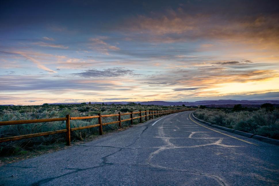 Free Image of Sunset over a peaceful desert road 