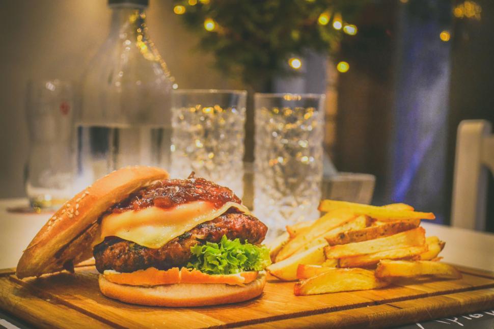 Free Image of Gourmet burger served with fries and drinks 