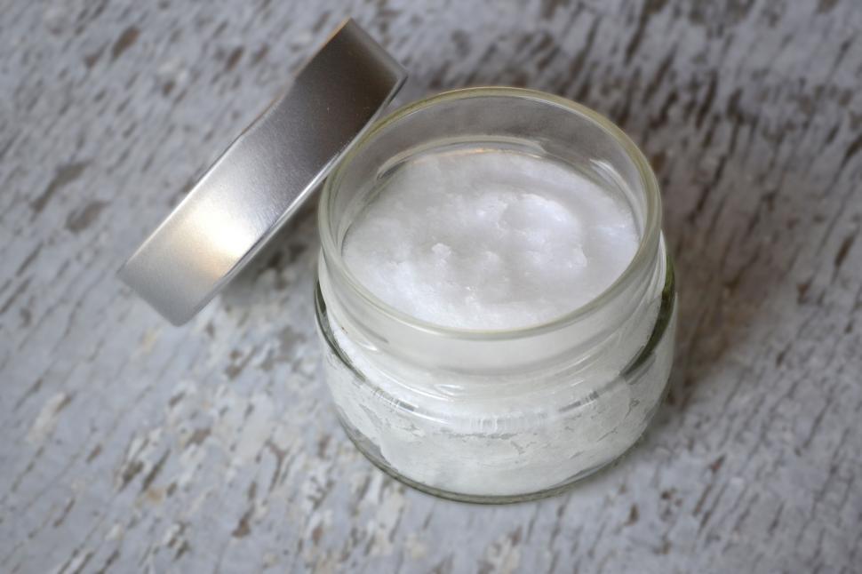 Free Image of Open jar of natural skin care product on table 