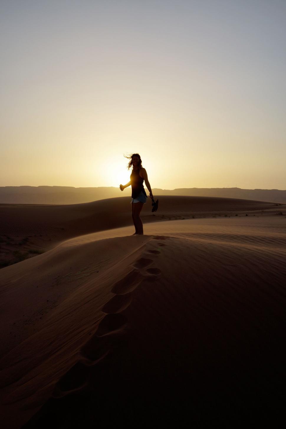 Free Image of Woman jogging at sunrise in the desert 