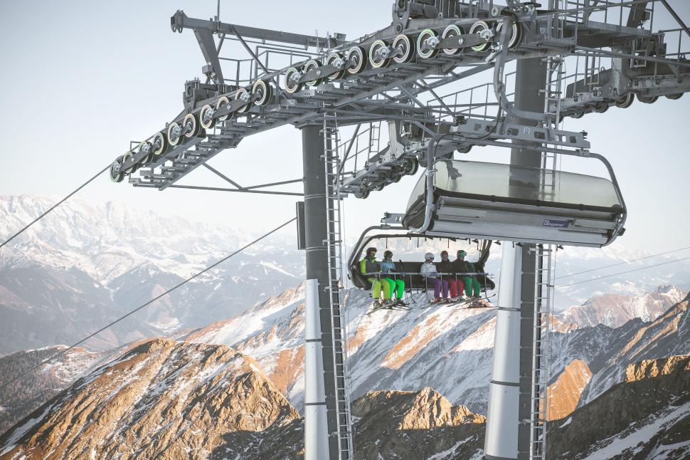 Free Image of Ski lift with passengers ascending 