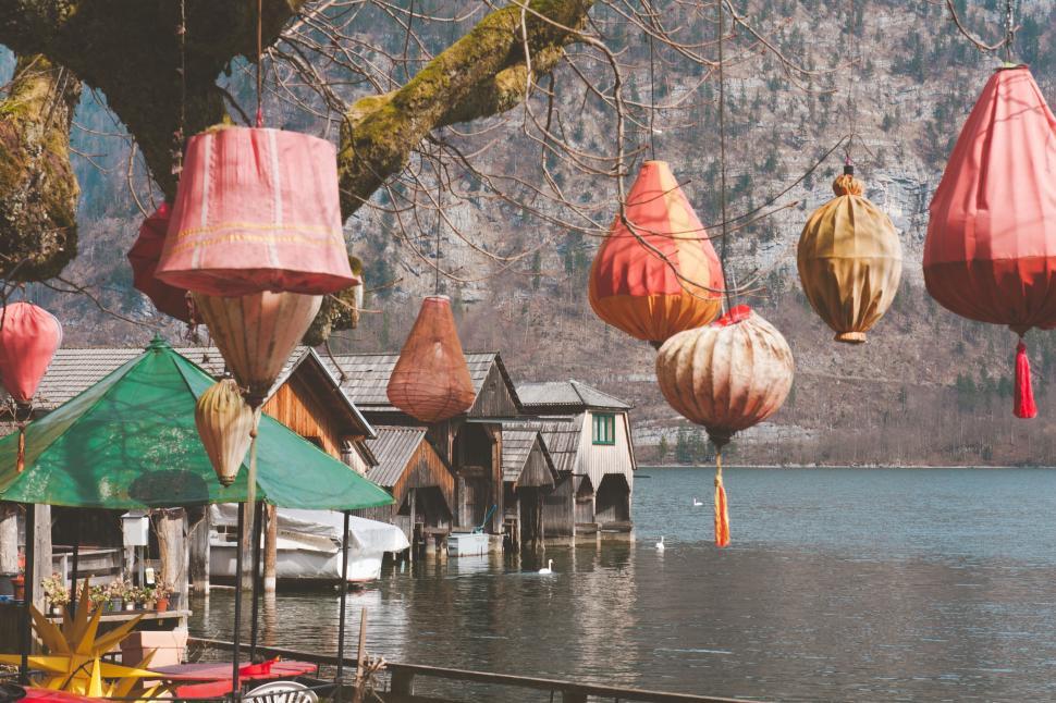 Free Image of Lanterns hanging over lakeside boathouses 