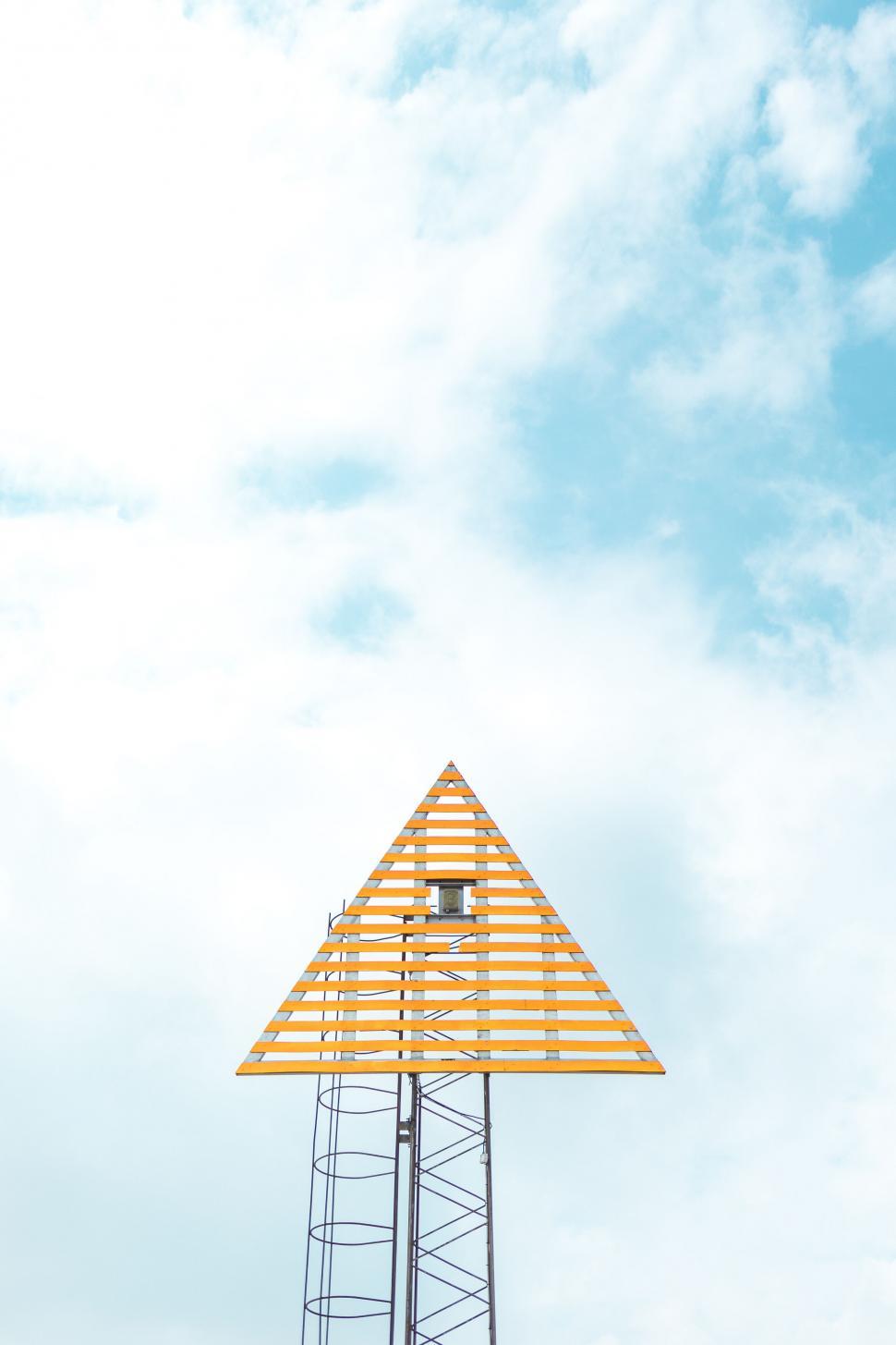 Free Image of Minimalist triangle structure against sky 
