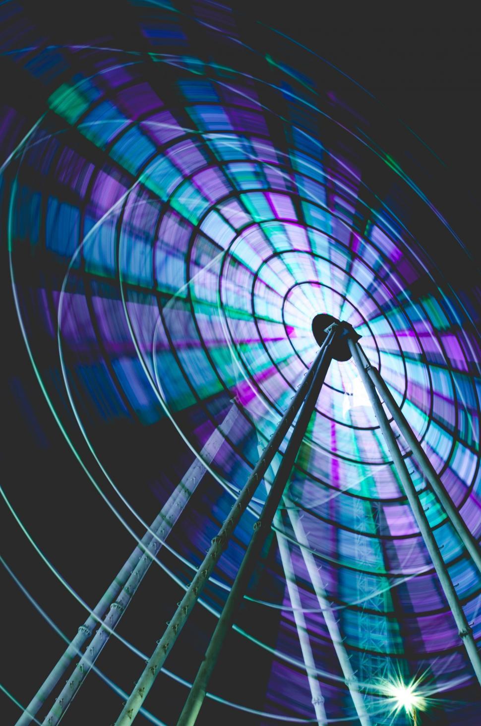 Free Image of Spinning Ferris wheel in vibrant colors 