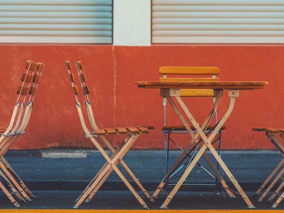 Free Image of Empty chairs in front of vibrant wall 