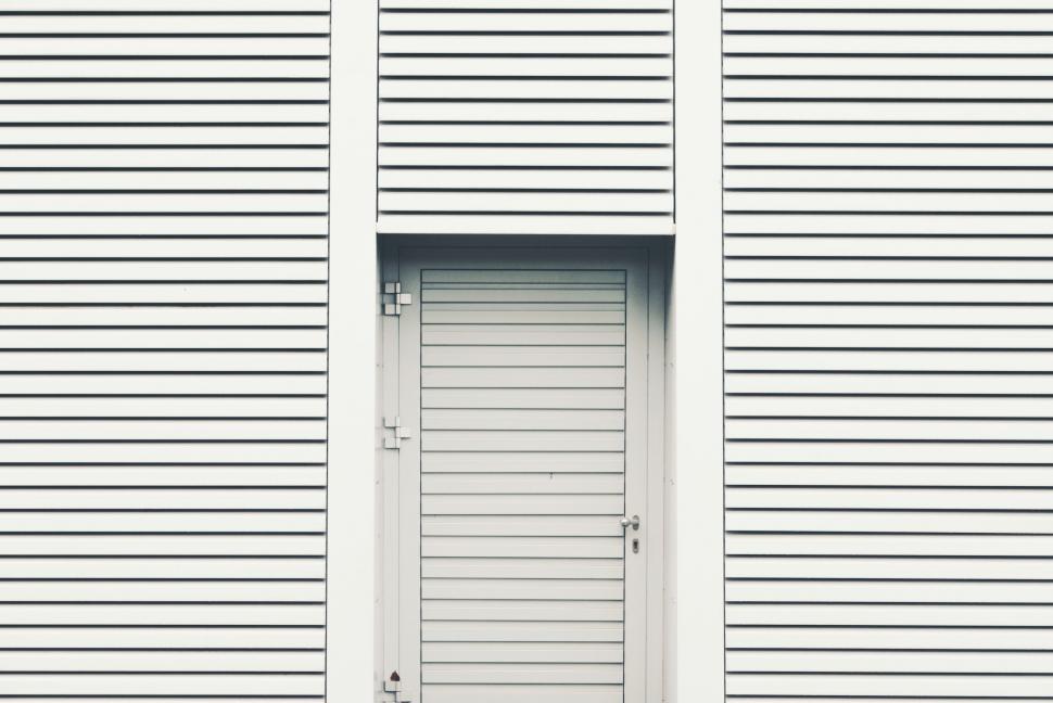 Free Image of Minimalistic white garage door with secure lock 