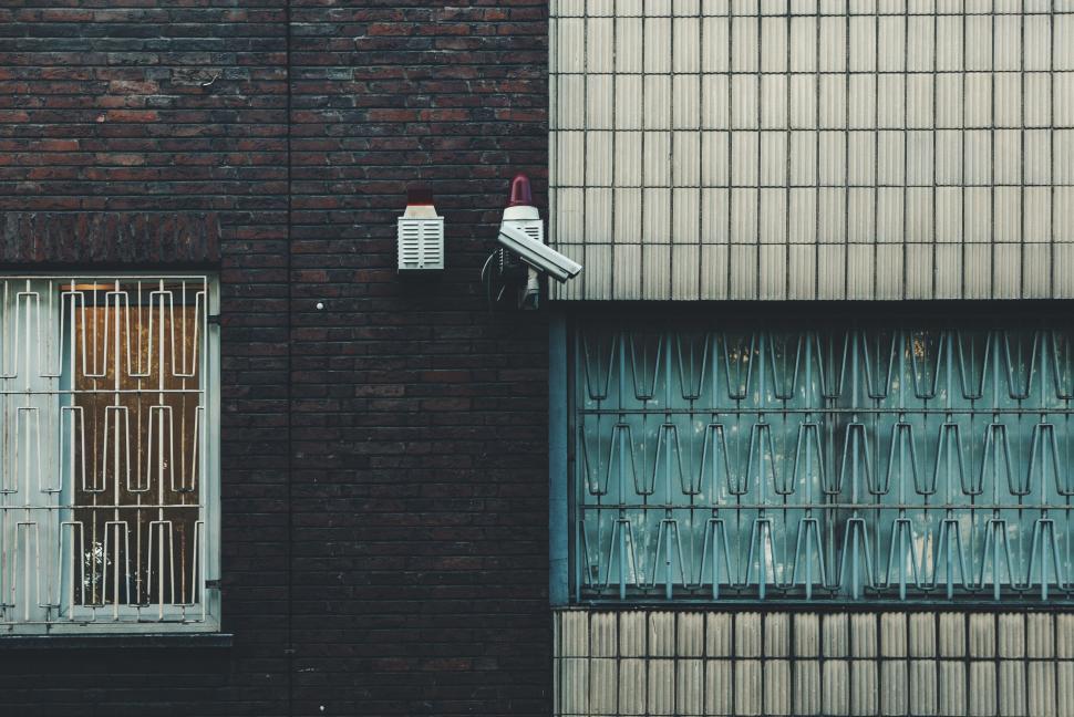 Free Image of Urban wall with windows and contrasting textures 