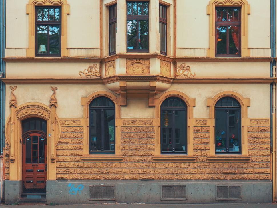 Free Image of Classic yellow building facade with ornate details 