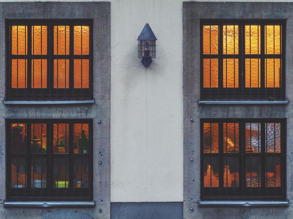 Free Image of Warm glow through windows of a concrete building 