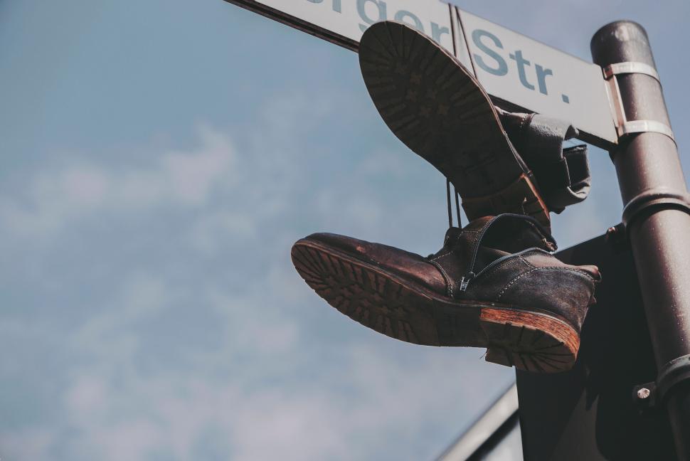 Free Image of Shoes hanging on street sign 