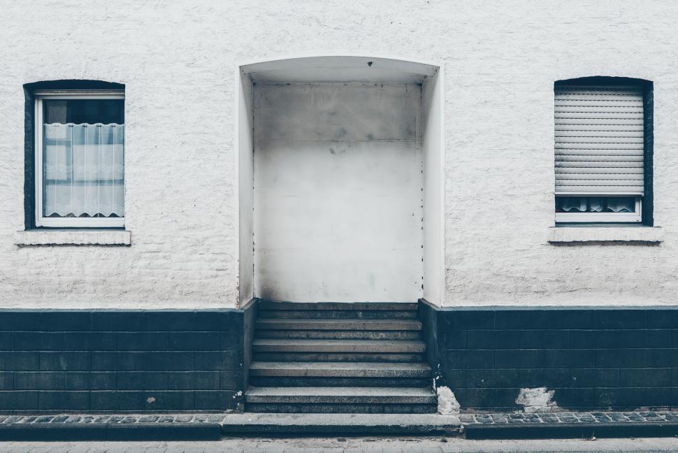 Free Image of White wall with closed door and two windows 