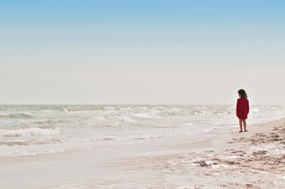 Free Image of Little girl at beach looking at sea 
