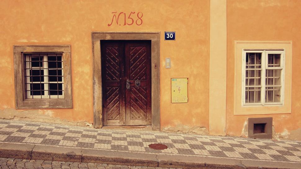 Free Image of Vintage orange facade with a wooden door 