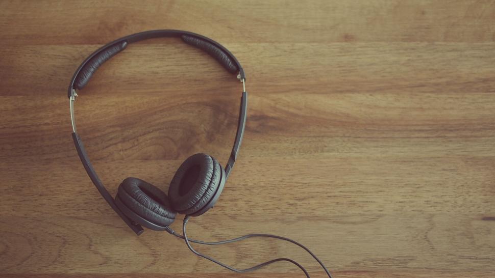 Free Image of Headphones lying on a wooden surface 