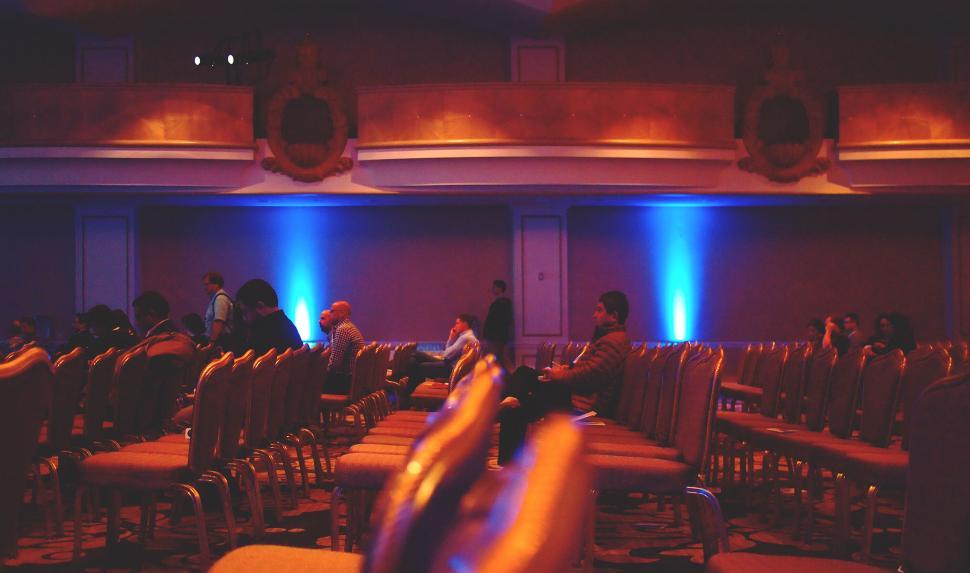 Free Image of Empty seats in a dimly lit conference hall 