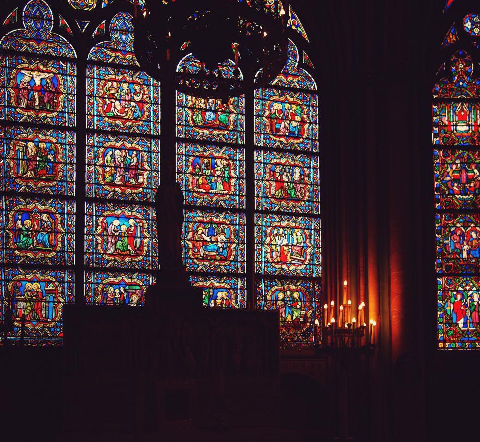 Free Image of Stained glass windows illuminating church interior 