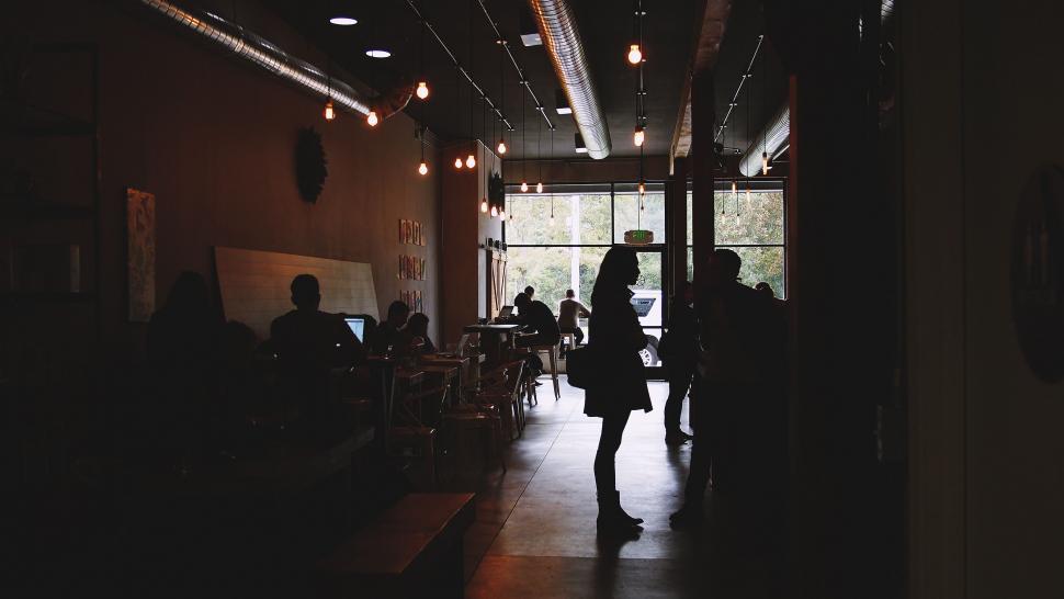 Free Image of Silhouette of a person in a cozy cafe 