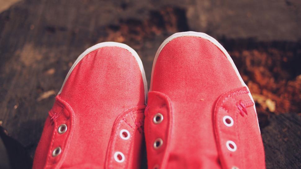 Free Image of Close-up of red canvas shoes on ground 
