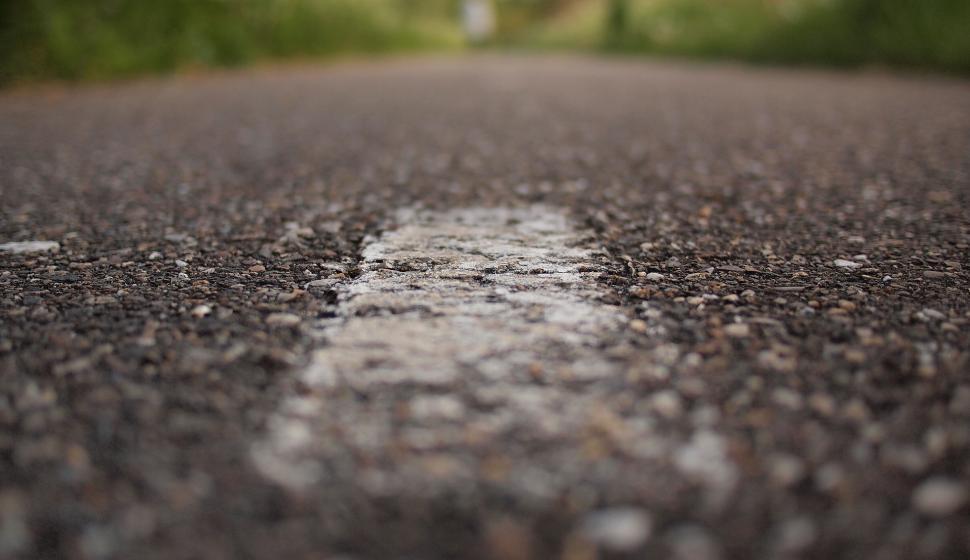 Free Image of Close-up shot of white road marking on asphalt 