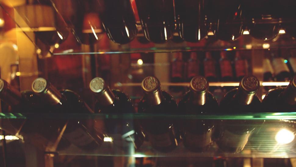 Free Image of Elegant wine bottles in a glass cabinet 