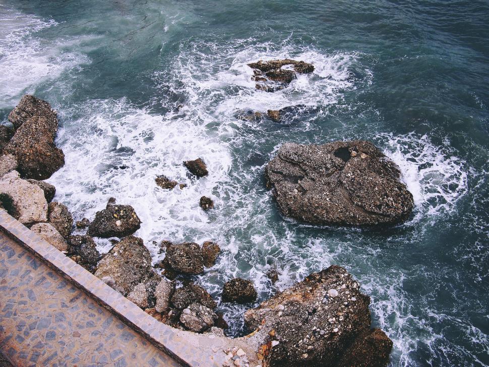 Free Image of Rugged coastal rocks against ocean waves 