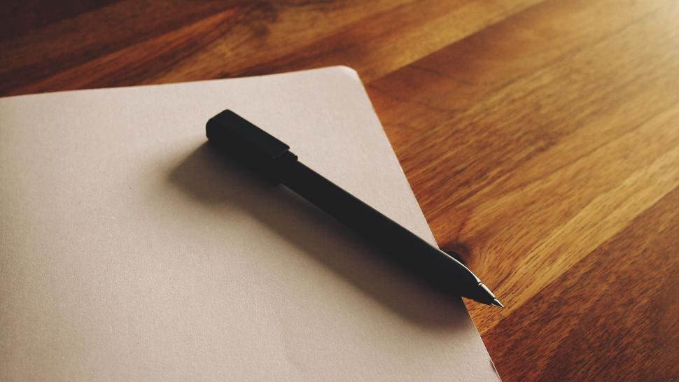 Free Image of Black pen on a blank notebook page 