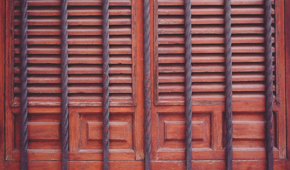 Free Image of Wooden shutters on an aged red building wall 