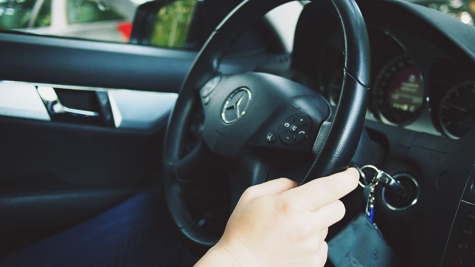 Free Image of Hand holding car keys in Mercedes car 