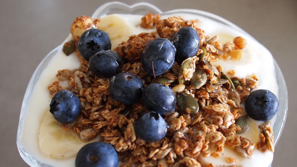 Free Image of Top view of a yogurt with blueberries and granola 