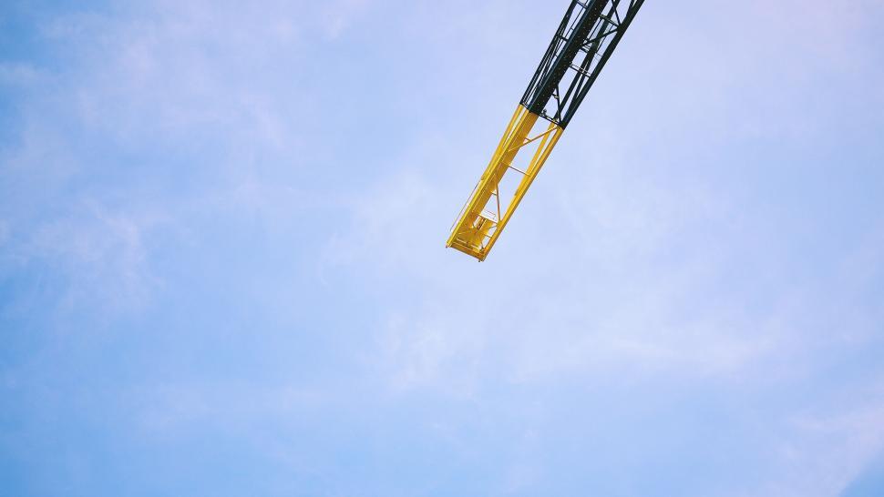Free Image of Yellow crane against bright blue sky 