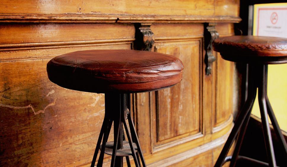 Free Image of Vintage bar stools against wooden backdrop 