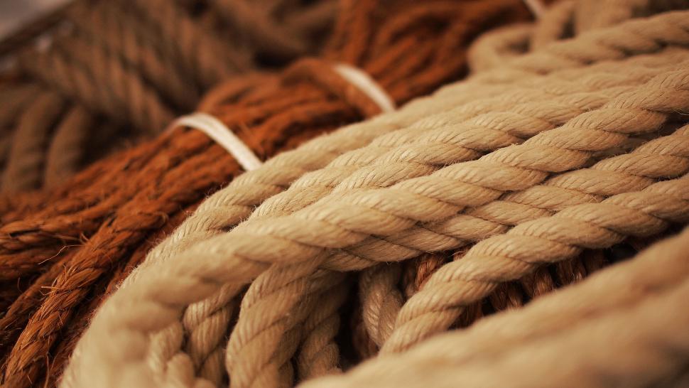 Free Image of Closeup of intertwined ropes in warm tones 