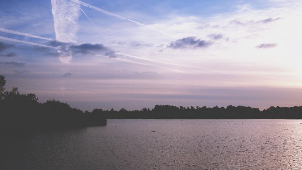 Free Image of Twilight sky over tranquil waters and trees 